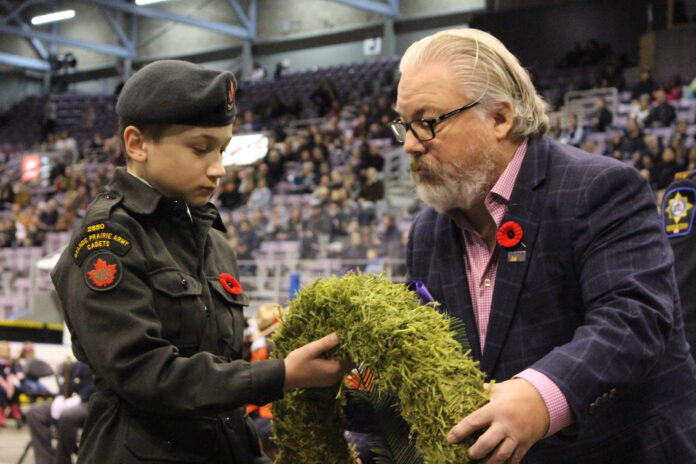 An Army Cadet passes Councillor Kevin O'Toole a wreath (Ethan Montague, mygpnow.com staff)