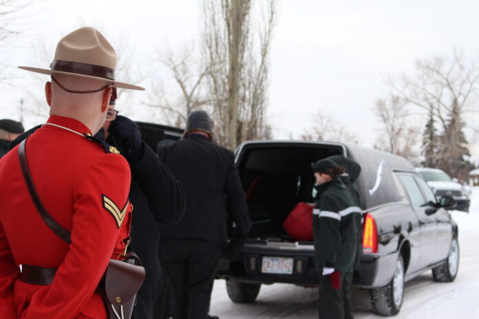 Cadets prepare to move flags from hearse to cemetery plot (Ethan Montague, MyGPNow Staff)